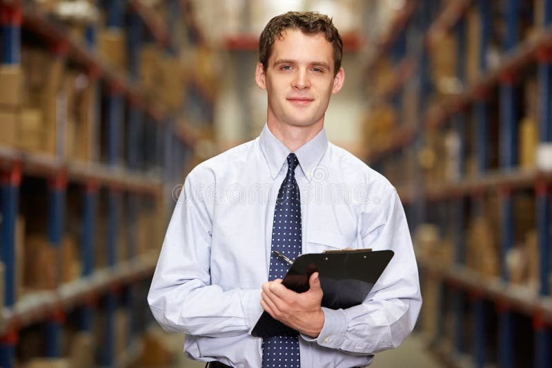 Portrait Of Manager In Warehouse With Clipboard stock photos Portrait Of Manager In Warehouse With Clipboard stock photos