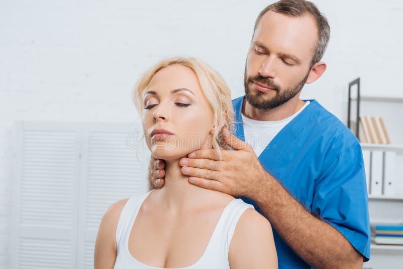 Portrait Of Massage Therapist Massaging Neck Of Young Woman Stock Image Image Of Medicare