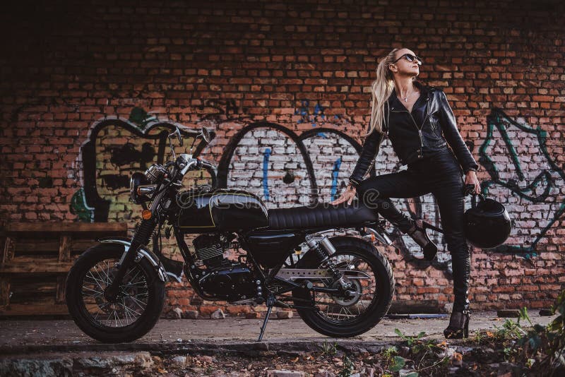 Female Biker in Black with Her Motorbike Next To Graffity Wall Stock ...