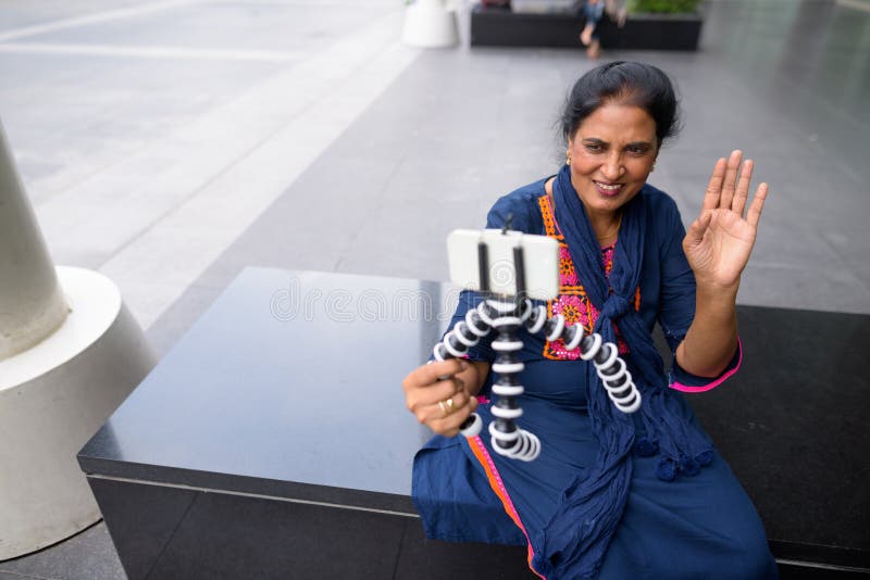 Mature Beautiful Indian Woman Vlogging Using Mobile Phone Stock Photo