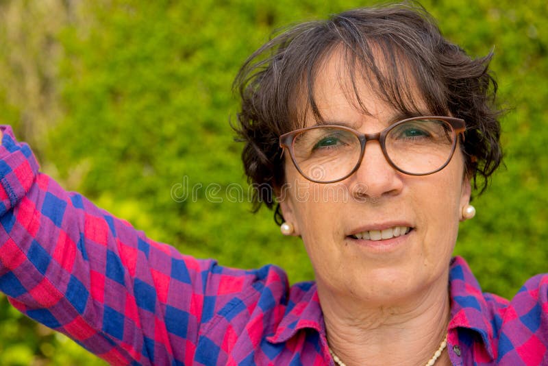 Portrait of a Mature Brunette Woman with Eyeglasses, Outdoor Stock