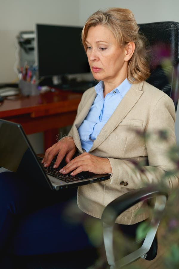 Portrait Of Mature Female Boss Talking On Phone In Office Stock Photo Image Of Businesswoman