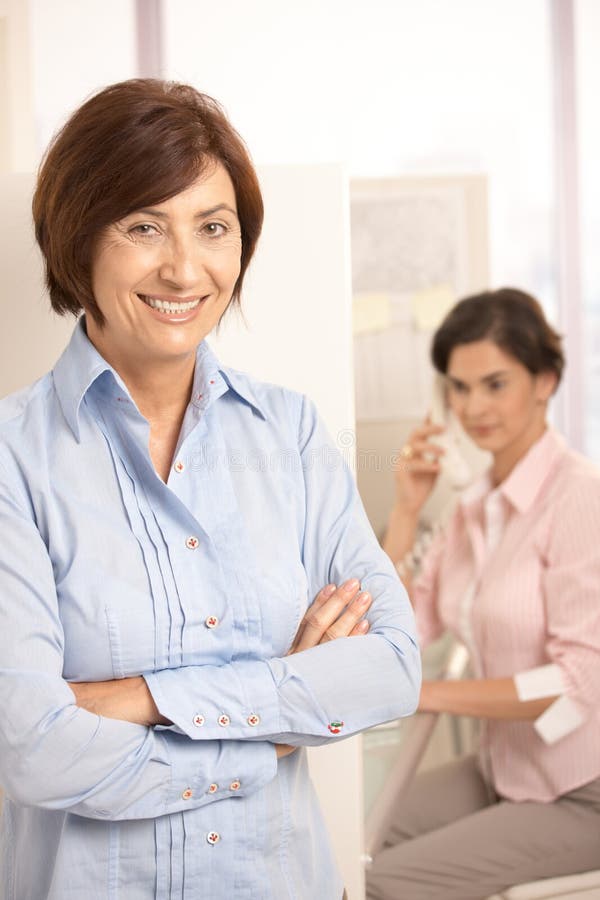 Portrait of mature office worker smiling at camera royalty free stock images