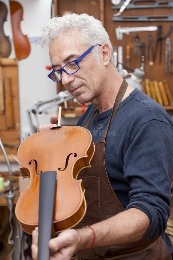 Portrait of mature violin maker