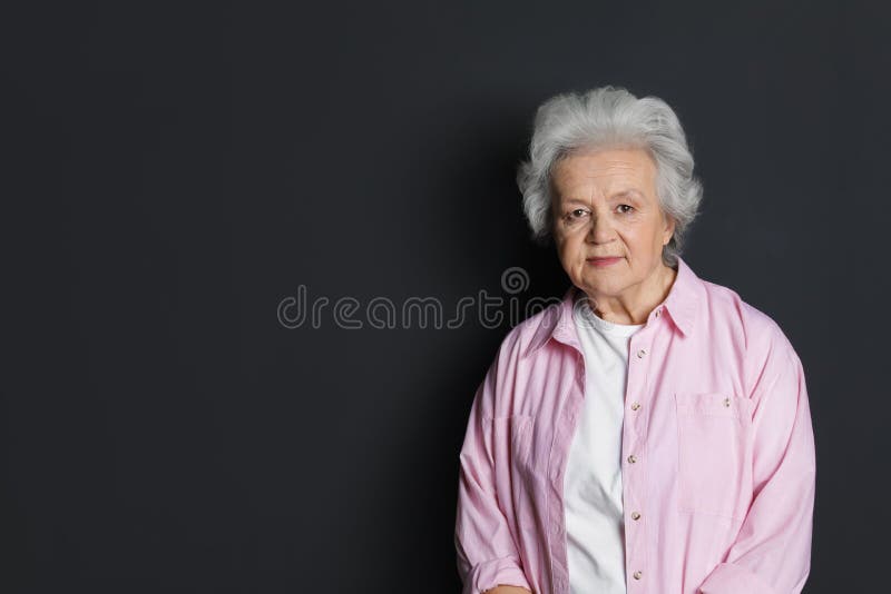 Portrait of mature woman on black background. stock photos