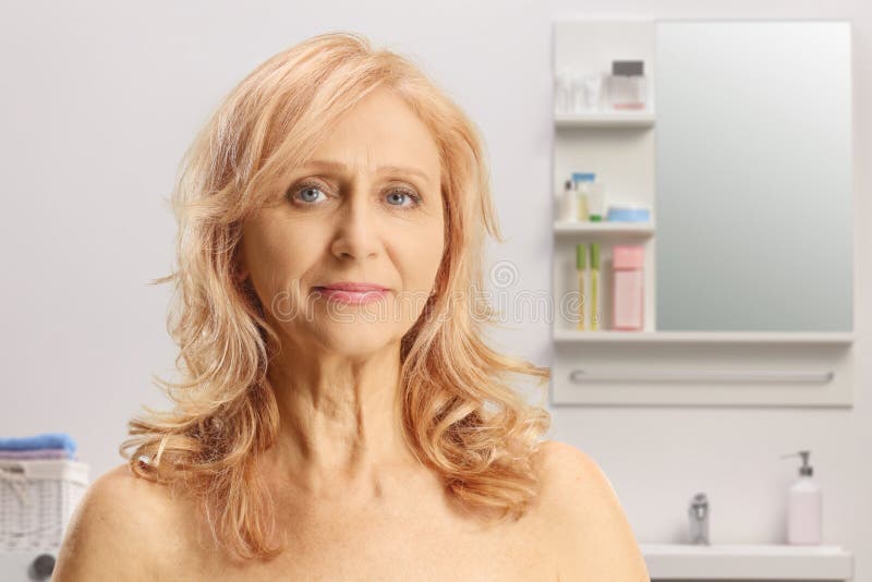 Portrait Of A Mature Woman With Blue Eyes And Bare Shoulders In A