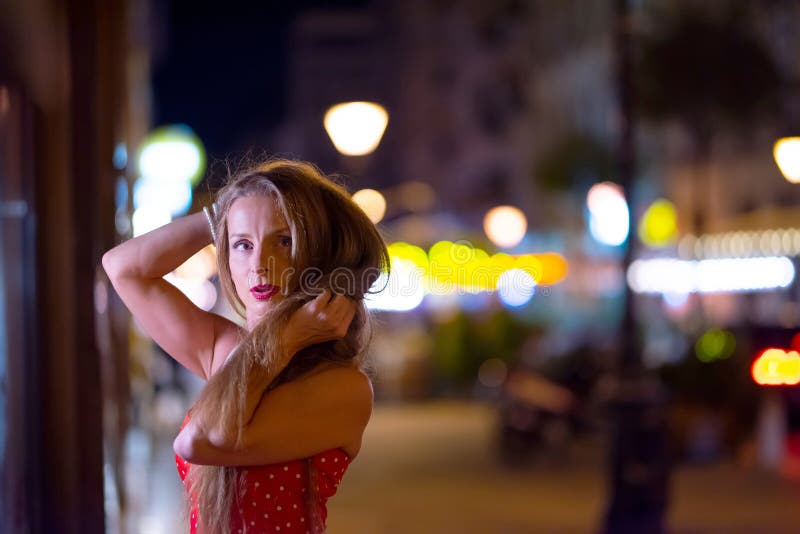 A Mature Woman Sitting on the Stairs at Night Stock Photo - Image of ...