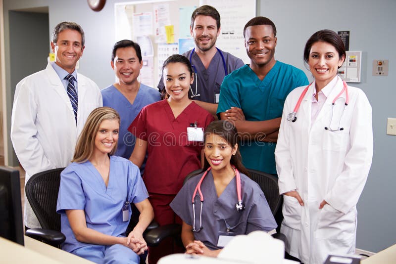 Ritratto Di Medical Team Infermieri Stazione Di Indossare Scrub Sorridente Alla Macchina Fotografica.