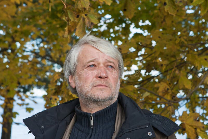 Portrait of middle-aged man in autumn day.