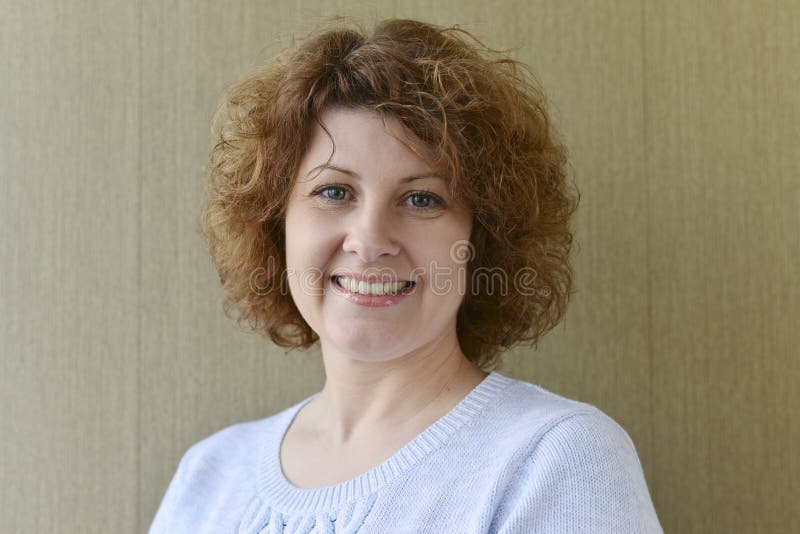 Portrait of middle-aged woman with curly hair