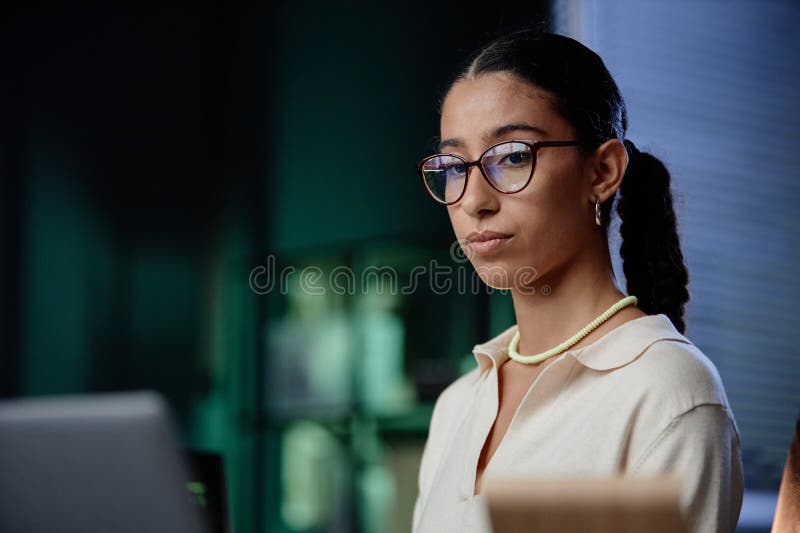 Portrait of Middle Eastern Female Programmer with Glasses Using Computer at Workplace royalty free stock images