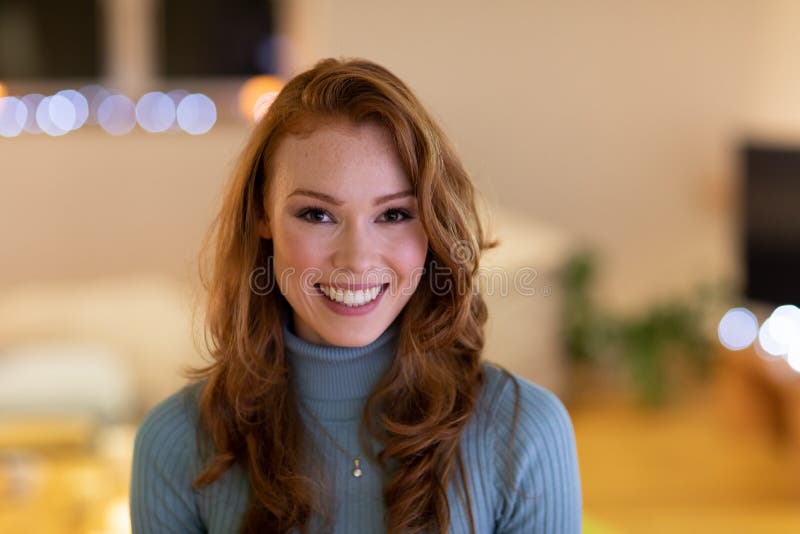 Portrait of millennial woman smiling at home