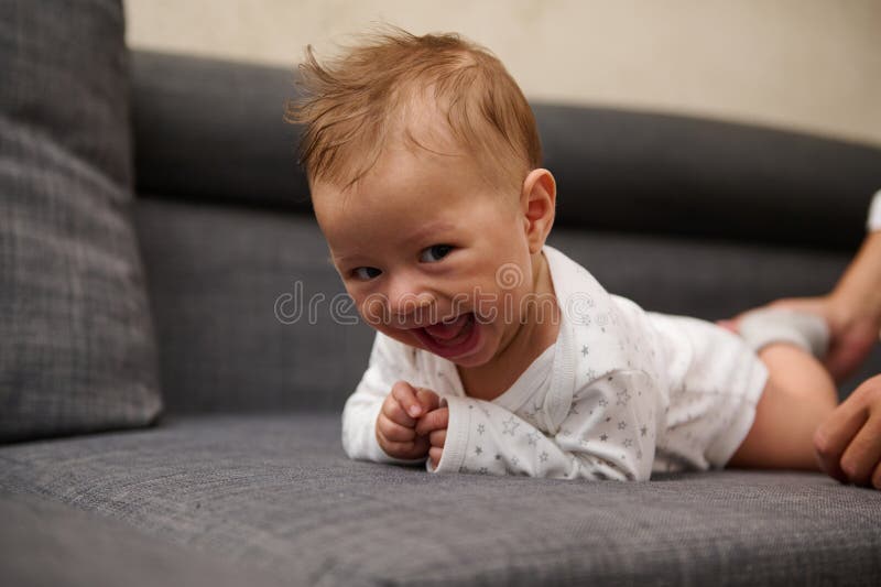 Mischievous Cheerful Funny Happy Baby Boy 5 Month Old, Lying on His ...