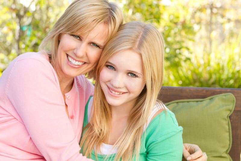 Portrait of a mother and daughter hugging. 