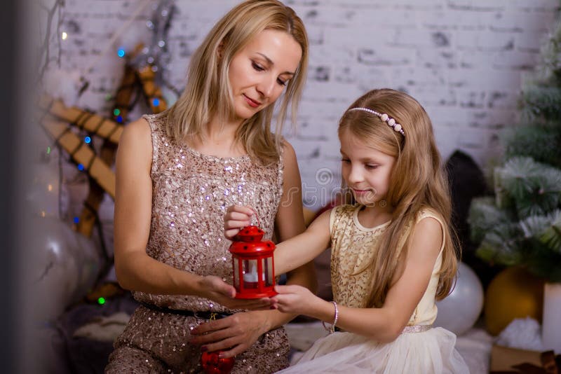 Portrait of a mother with her daughter. Christmas tale