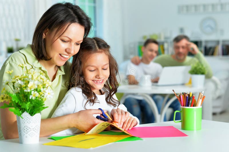 Portrait of mother teaches her cute little daughter