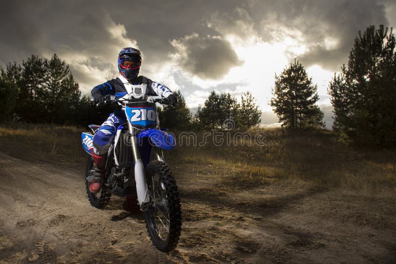 A Portrait of Motocross Rider Sitiing on the Bike on the Background of  Sunset Stock Photo - Image of racer, cross: 102921914