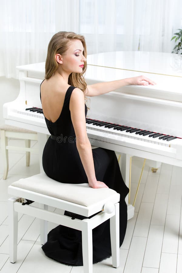 Portrait of musician sitting and playing piano