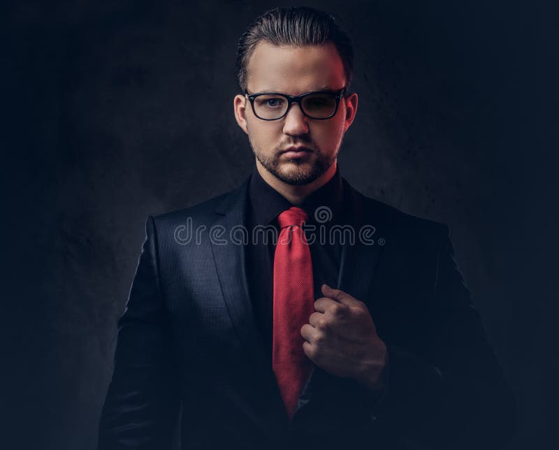 Portrait Of A Stylish Male In A Black Suit And Red Tie. Isolated On A ...