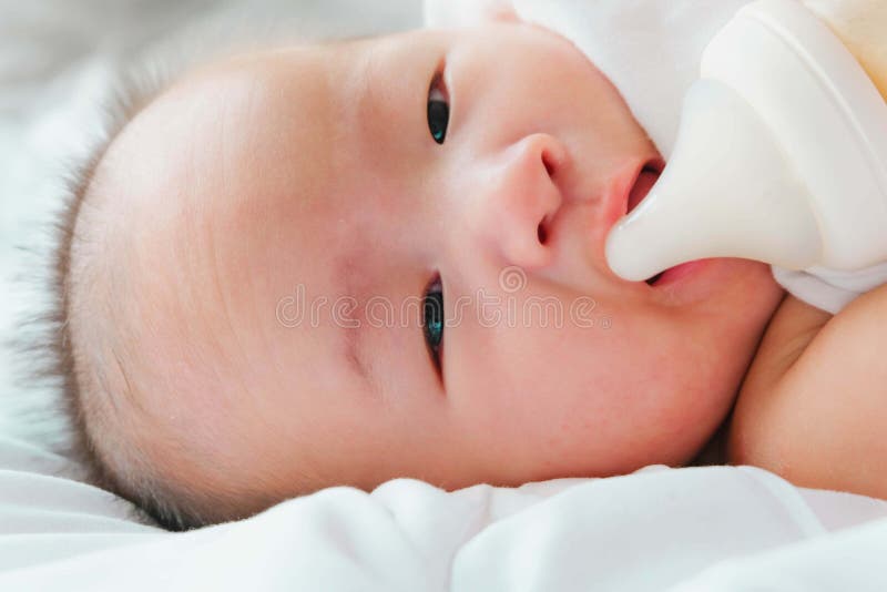 https://thumbs.dreamstime.com/b/portrait-newborn-asian-baby-bed-drinks-milk-bottle-charming-black-eyed-month-old-lies-child-resting-175123198.jpg