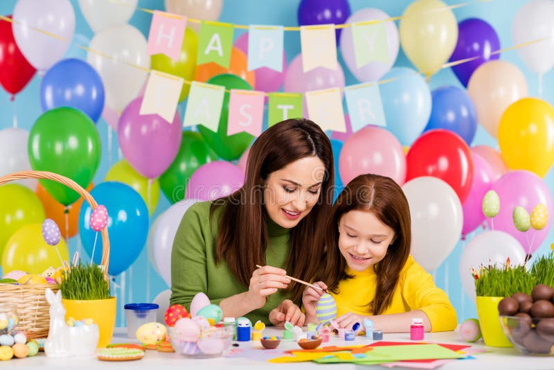 Portrait of nice attractive lovely creative tender cheerful cheery girls enjoying painting eggs mom mum teaching small stock photo Portrait of nice attractive lovely creative tender cheerful cheery girls enjoying painting eggs mom mum teaching small stock photo