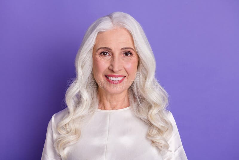 Portrait of nice lovely old woman look good in camera toothy smiling wear white shirt over vivid color stock photo Portrait of nice lovely old woman look good in camera toothy smiling wear white shirt over vivid color stock photo