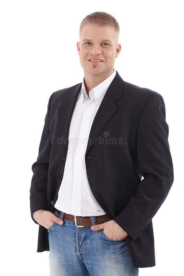 Casual businessman portrait, smiling confidently at camera with hands in pocket, isolated on white. Casual businessman portrait, smiling confidently at camera with hands in pocket, isolated on white.