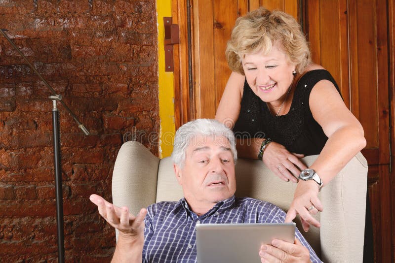 Old couple using tablet. royalty free stock photo