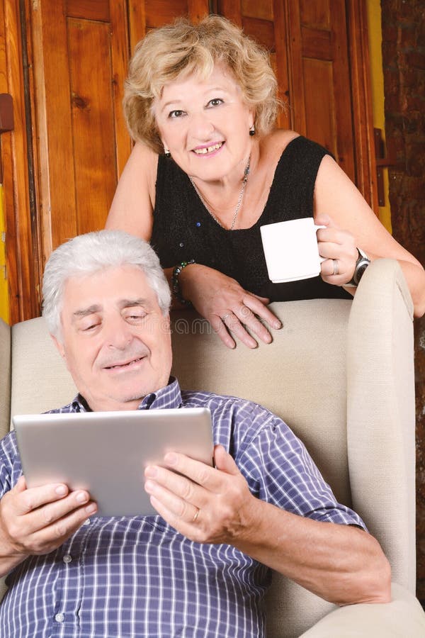 Old couple using tablet. royalty free stock image