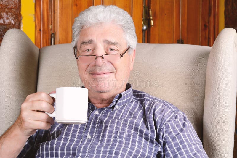Old man drinking coffee. stock photography