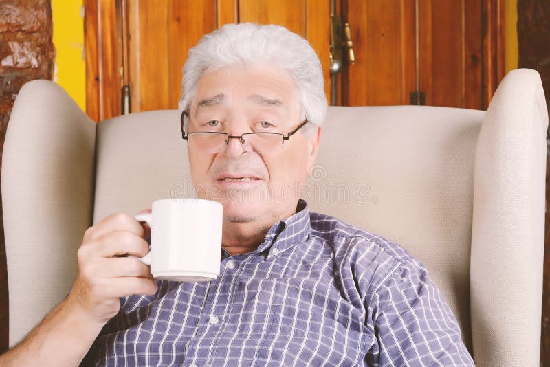 Old man drinking coffee. stock photo