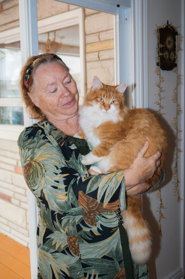 Portrait older woman with cat