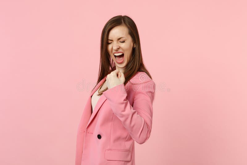 Portrait of overjoyed screaming young woman with closed eyes clenching fist like winner on pastel pink stock images Portrait of overjoyed screaming young woman with closed eyes clenching fist like winner on pastel pink stock images