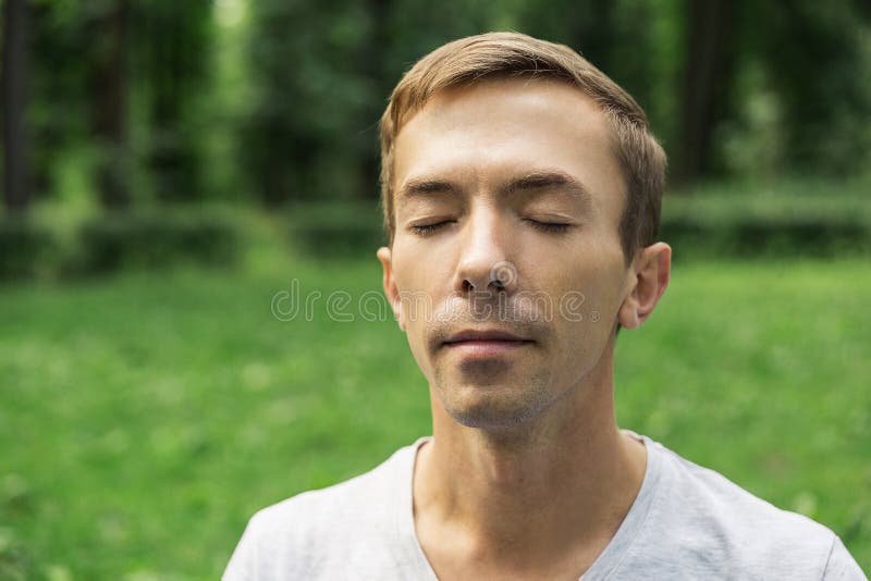 Portrait of the pacified face of a young attractive man with his eyes closed stock photo Portrait of the pacified face of a young attractive man with his eyes closed stock photo
