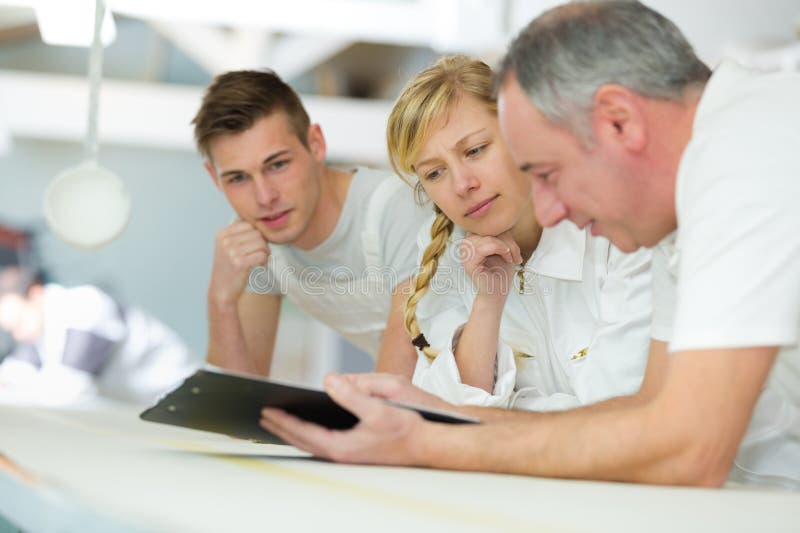 Portrait painter with apprentices royalty free stock photography