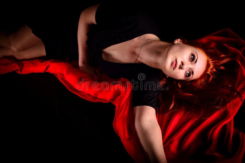 Portrait of passionate effective woman on black