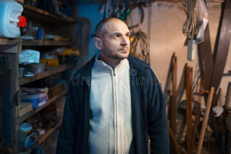 Portrait of pensive adult man in his workshop room stock images Portrait of pensive adult man in his workshop room stock images