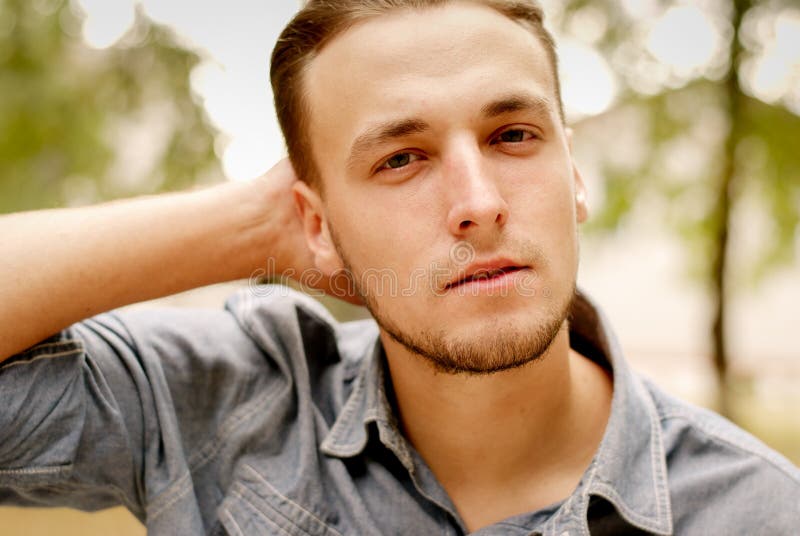 Portrait of a pensive young man with a beard. Nice, handsome.