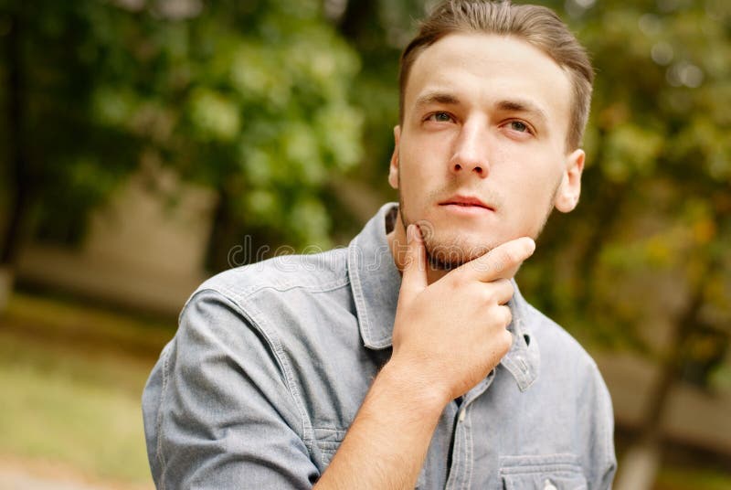 Portrait of a pensive young man with a beard. Posing, beautiful.