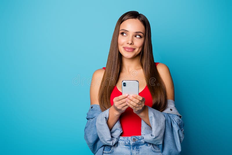 Portrait of positive cheerful addicted social network user girl use smartphone look copyspace have online communication