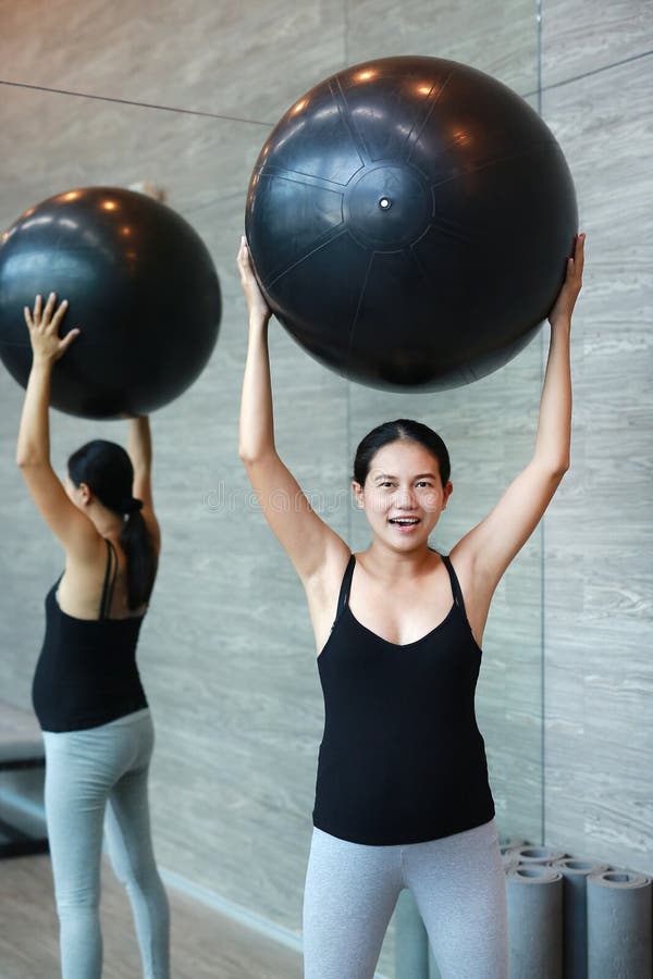 Portrait of pregnant woman exercising with fitball at sports hall stock images Portrait of pregnant woman exercising with fitball at sports hall stock images