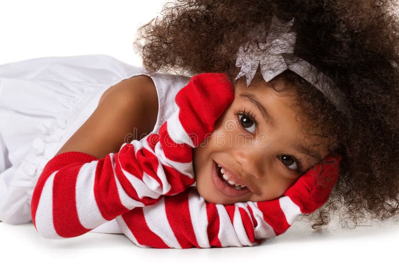 Portrait of a preschool child girl laying down. Studio shot. Isolated