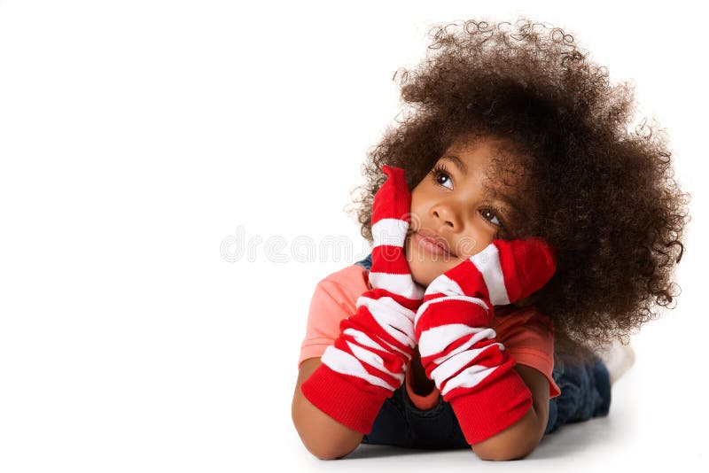 Portrait of a preschool child girl laying down. Studio shot. Isolated