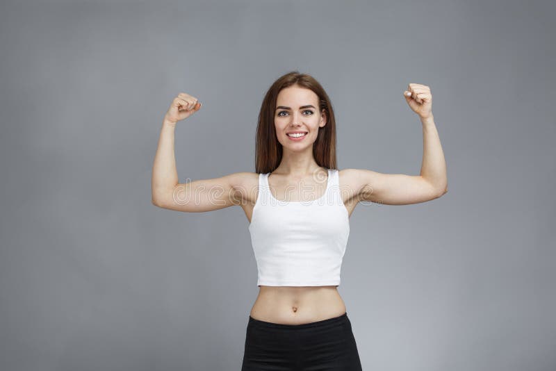 Woman Shows Her Muscular Arms Over Gray Background Stock Image - Image of  muscles, athletic: 169916311