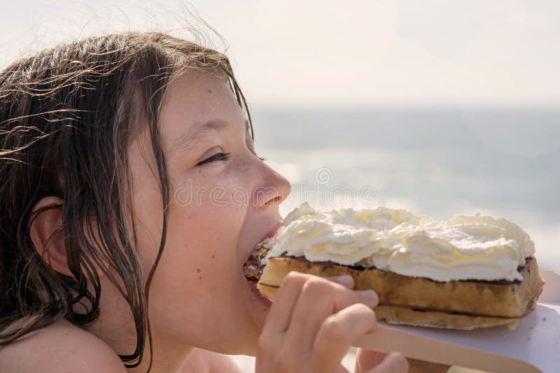10. Little girl with blond hair and a big smile eating ice cream - wide 1