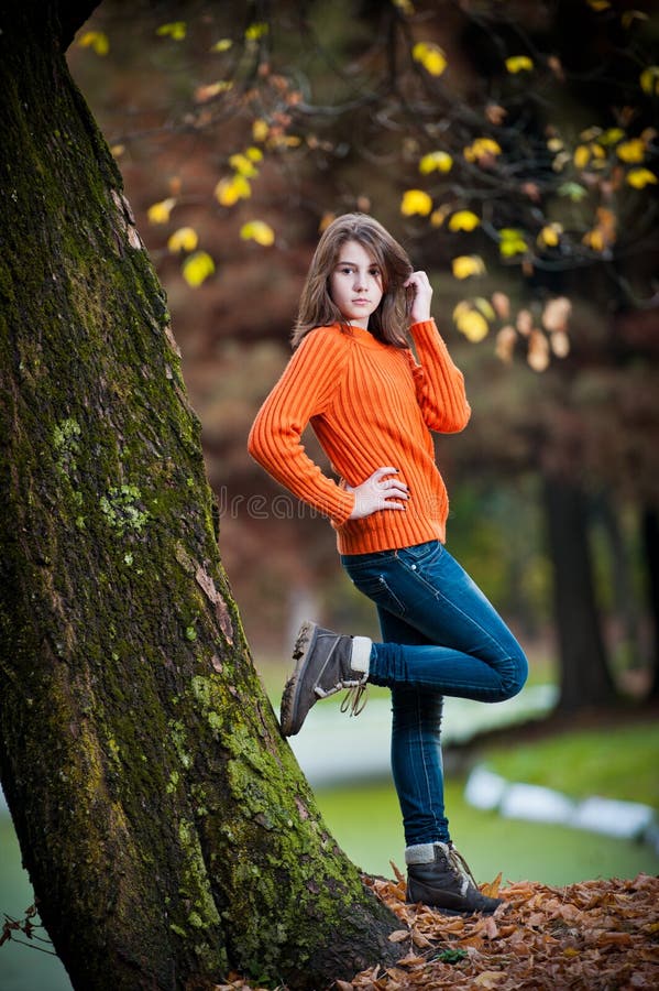 Portrait of pretty teen girl in autumn park