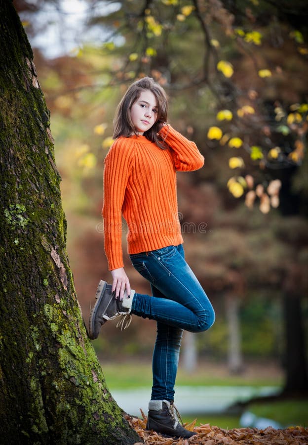 Portrait of pretty teen girl in autumn park