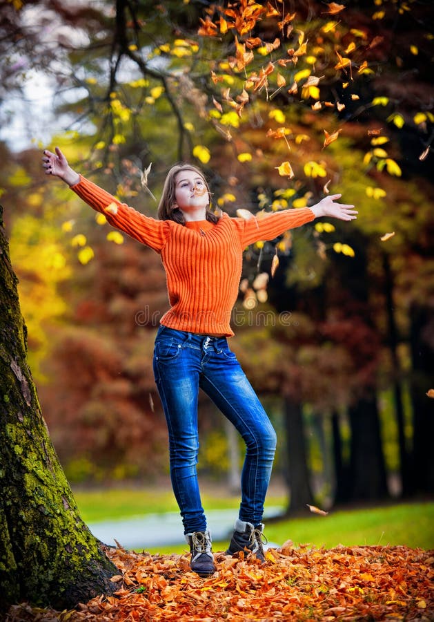 Portrait of pretty teen girl in autumn park