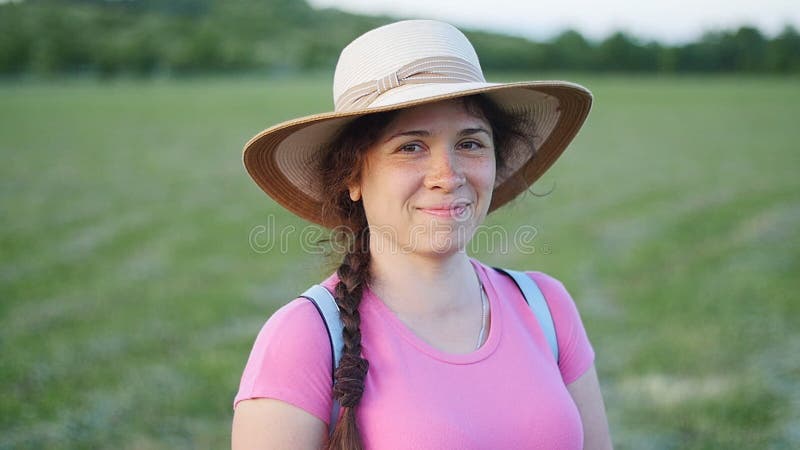 Portrait of pretty young lady in hat in a park