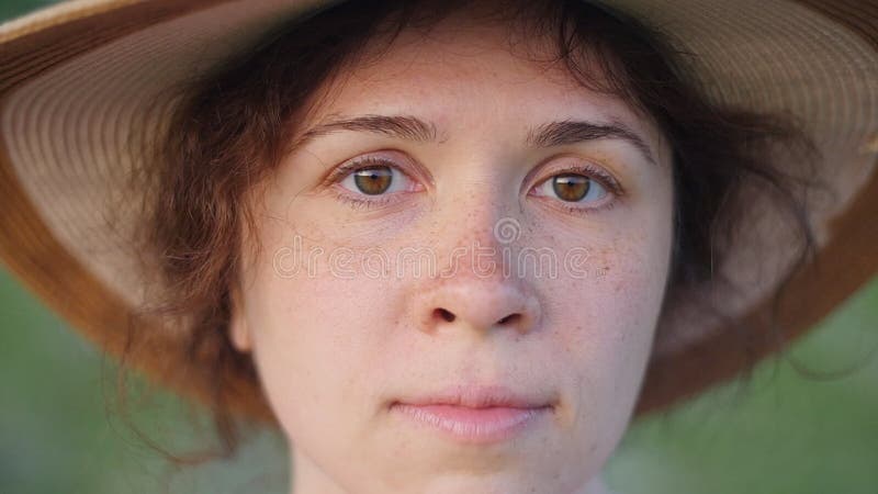 Portrait of pretty young lady in hat in a park